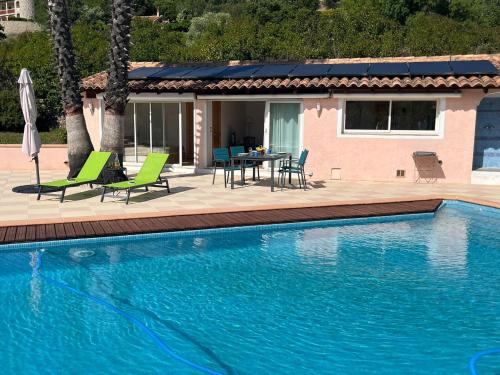 - une piscine avec une table et des chaises à côté d'une maison dans l'établissement Petite Villa indépendante - Grande piscine 12x8, à Carqueiranne
