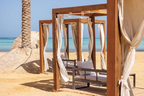 a swing on the beach with the ocean in the background at True Beach Resort in Marsa Alam City