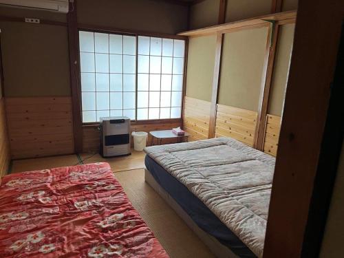 Postel nebo postele na pokoji v ubytování Futago Cabin