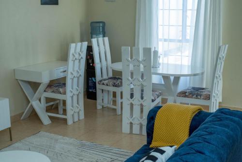 a living room with a couch and a table and chairs at Eldoret home, Q10 unity homes in Eldoret