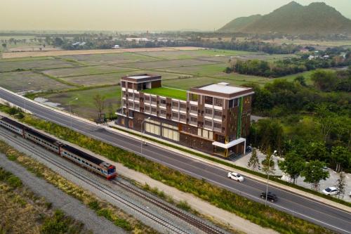 a rendering of a building next to a highway at YSW Hotel Lopburi in Ban Khok Krathiam