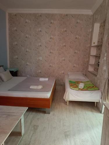 two beds in a small room with two bedsvisor at Guest House Nise in Tbilisi City