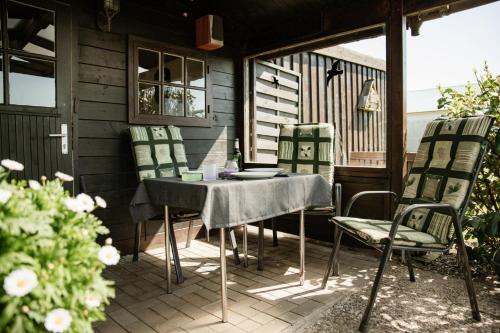 a table and chairs sitting on a patio at Ferienwohnung Hohner Seeblick in Hohn
