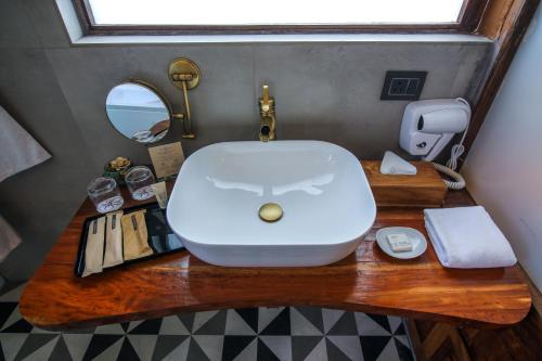 a bathroom with a sink and a mirror on a table at Toyam by Orchid Hotels in Bhor