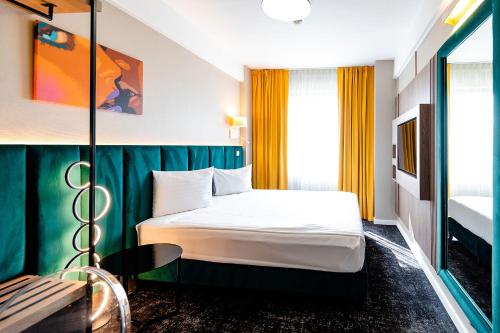 a hotel room with a bed and a table at Business Hotel Conference Center & Spa in Târgu-Mureş