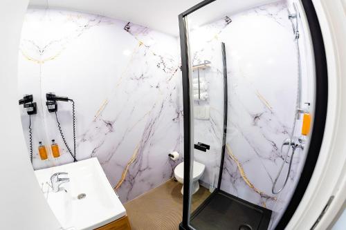 a bathroom with a shower and a sink at Business Hotel Conference Center & Spa in Târgu-Mureş