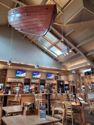 a boat hanging from the ceiling of a restaurant at LOIRE in Skegness