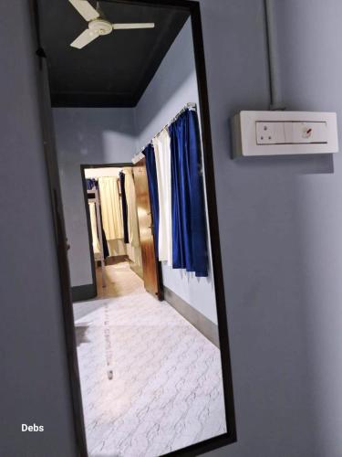 a mirror reflection of a hallway in a room at Faith Dorms in Siliguri