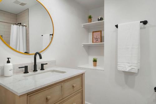 a bathroom with a sink and a mirror at Large Home, 2 Living Rooms, Great for Family/Pets! in Arvada