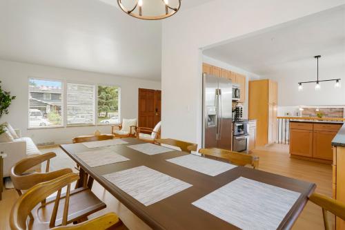 a kitchen and dining room with a table and chairs at Large Home, 2 Living Rooms, Great for Family/Pets! in Arvada