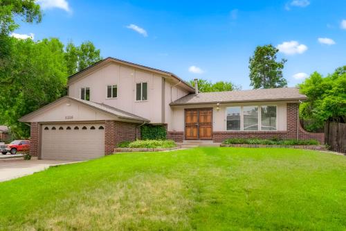 a house with a green lawn at Large Home, 2 Living Rooms, Great for Family/Pets! in Arvada