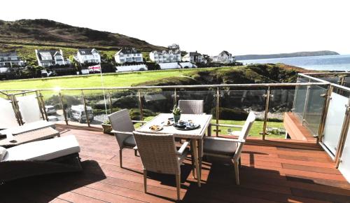 a patio with a table and chairs on a balcony at Watersmeet Hotel in Woolacombe