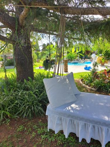 a swinging bed in a yard with a pool at villa in paradise in Zipárion