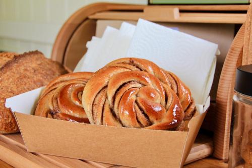 a box of cinnamon rolls and bread on a table at Peatlands in Ballybogy
