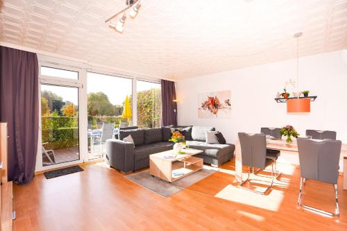 a living room with a couch and a table at Golfresidenz Whg A14 in Grömitz