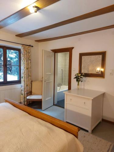 a bedroom with a bed and a bathroom with a tub at Flow In chill out in Kitzbühel