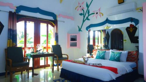 a bedroom with a bed in a room with aintendent at MG Chateau Resort in El Nido