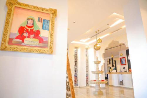 a painting of a woman on a wall in a room at نزل قايا Hôtel Gaïa in Nabeul