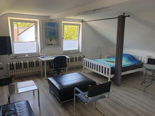 a bedroom with a bed and a table and a couch at Eiland-Apartment in Springe