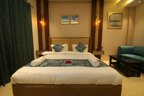 a hotel room with a bed and a chair at Hotel Dream Inn in Rishīkesh