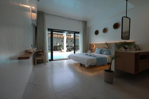 a large bedroom with a bed and a table and a desk at Diving Addiction Resort in Panglao Island