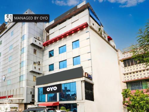 a white building with an omega sign on it at Collection O Heritage VIP Road in Kolkata