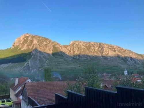 a view of a mountain with a village and houses at Long Rock Chalets in Rimetea