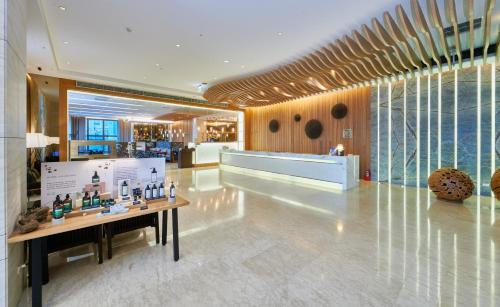 a lobby with a counter in the middle of a building at Grand Bay Resort Hotel in Hengchun