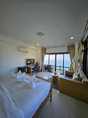 a bedroom with a bed and a living room at Phangan Utopia Resort in Mae Haad