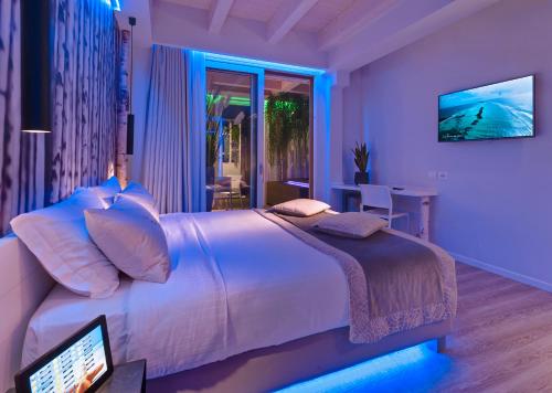 a bedroom with a large bed with a monitor on it at Hotel Locanda Al Piave ***S in San Donà di Piave