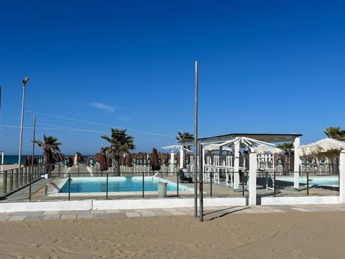 a swimming pool on the beach next to the beach at CLICCA PER L'OFFERTA Ad UN Passo dal MARE con Doccia JACUZZI in Pescara