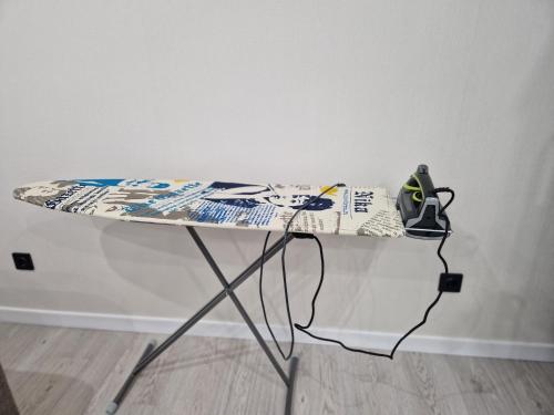 un tavolo con una tavola da surf sopra di essa di 1-комнатная возле Посольства США и Мечети Хазрет Султан a Astana
