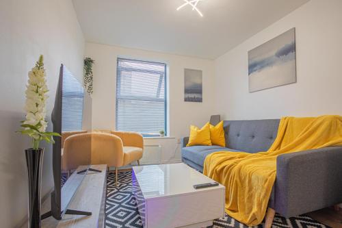 a living room with a bed and a couch at Beautiful Flat in Halifax - Perfect for Long Stays in Halifax