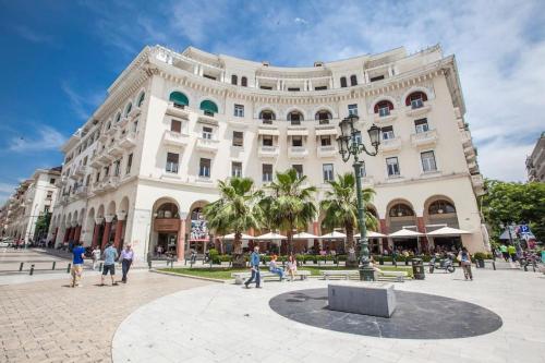 a large building with people walking in front of it at FsN Central Lofts 301 / 3P in Thessaloniki