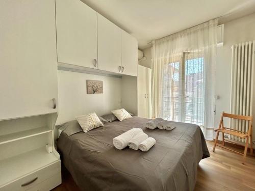 a bedroom with a bed with two towels on it at Nino Bixio Flexrent - Abissinia in Riccione