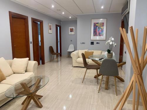 a living room with a white couch and a table at Home SEA&DREAMS Ifach in Calpe