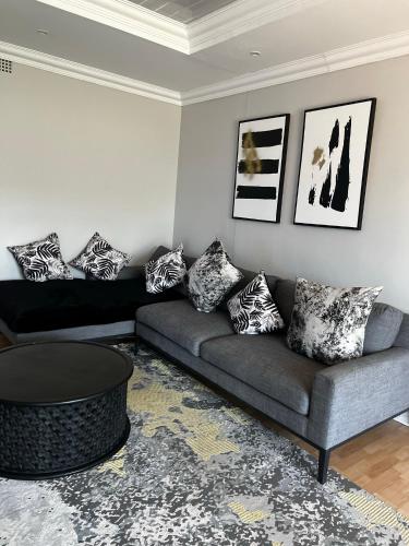 a living room with a couch and a table at Kimberly Luxury Suites in Kimberley