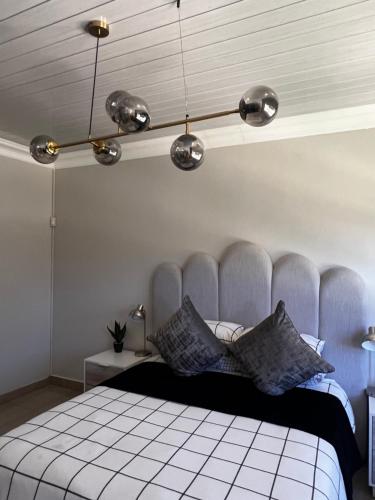 a bedroom with a blue and white bed with pillows at Kimberly Luxury Suites in Kimberley