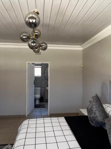 a room with a bed and a ceiling at Kimberly Luxury Suites in Kimberley
