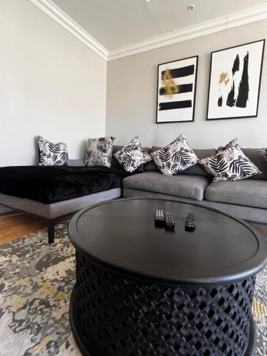 a living room with a couch and a table at Kimberly Luxury Suites in Kimberley