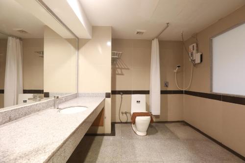 a bathroom with a toilet and a sink at Ritz Boutique Hotel in Pattaya South