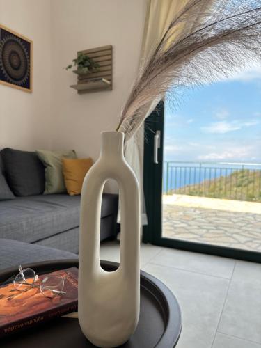 a white vase sitting on a table in a living room at Anemar Lefkada in Drymon