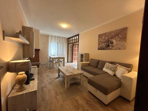 a living room with a couch and a table at Lago Idro Glamping Boutique in Anfo