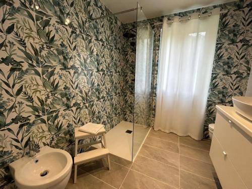 a bathroom with a shower and a toilet and a sink at Lago Idro Glamping Boutique in Anfo