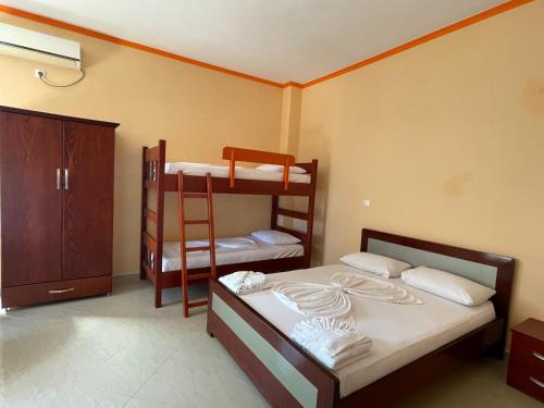 a bedroom with two bunk beds and a ladder at Vila Anna in Ksamil