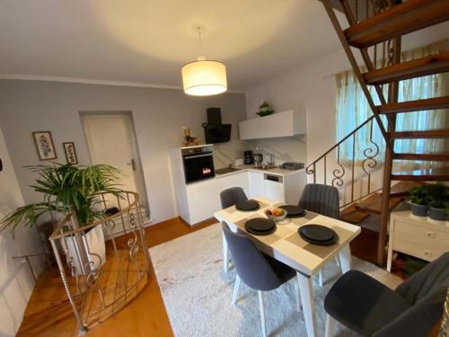a living room with a table and a kitchen at Lori House in Corfu. Feel like your home in Skriperón