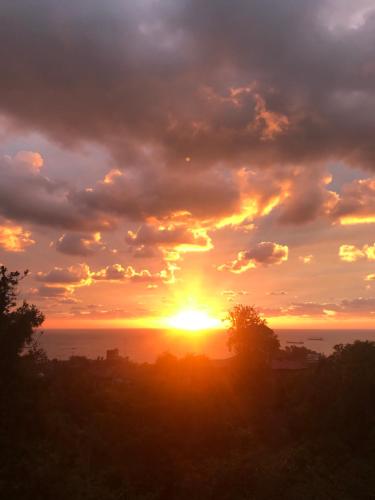 a sunset with the sun setting in the horizon at Green Hause Marina in Batumi