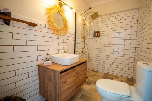 a bathroom with a white sink and a toilet at CasaLyma Ayvalık in Ayvalık