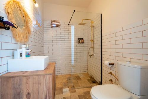 a bathroom with a white sink and a toilet at CasaLyma Ayvalık in Ayvalık