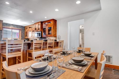 a kitchen and dining room with a wooden table and chairs at SNOW FLOWER 029 condo in Park City